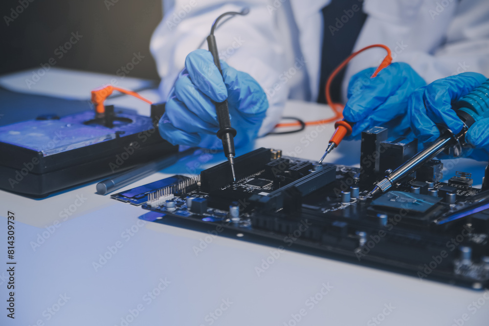 Naklejka premium Close up of Technician measuring voltage electronic circuit board television, Service after sale fix electric equipment within insurance.