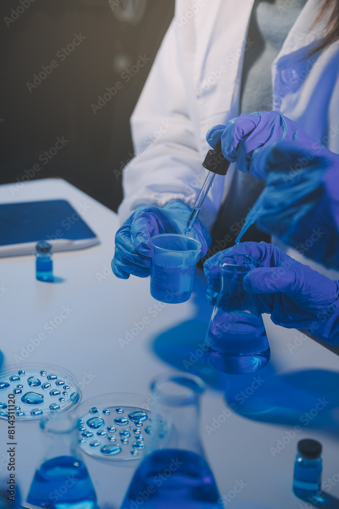 chemist,scientist hand dropping chemical liquid into test tube, science research and development concept chemist,scientist hand dropping chemical liquid into test tube, science research and development concept