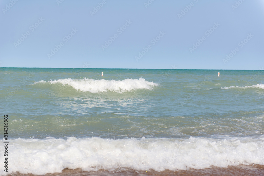 Beach near Lake Michigan. Rough waves. Two waves on the water. Beach near Lake Michigan. Rough waves. Two waves on the water.