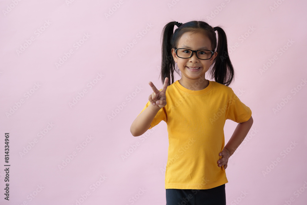 Close-up photo of a cute little girl, cheerful, smart, good at learning, new ideas, and imagination. Expressing various poses based on bright life concept, copy space, and pink pastel background.