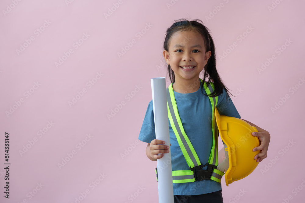 Female engineer, a little girl standing, smiling, holding a yellow helmet. Repairman. Construction engineer. The dream career of young Asian girls in the future. Female engineer, a little girl standing, smiling, holding a yellow helmet. Repairman. Construction engineer. The dream career of young Asian girls in the future.