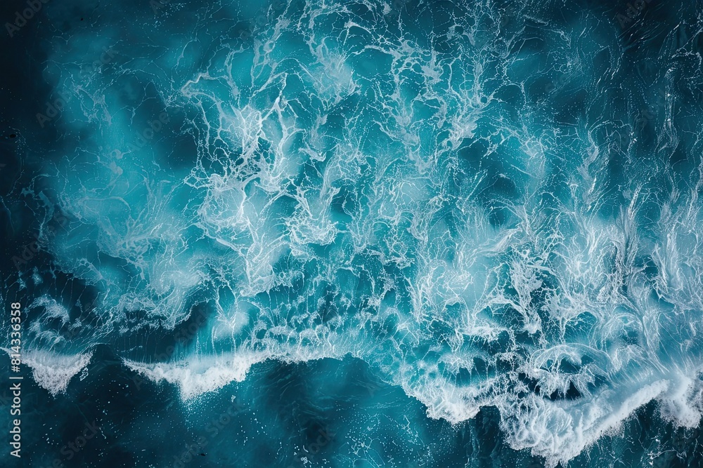 Coast with waves as a background from top view. Blue water background from drone. Summer seascape from air