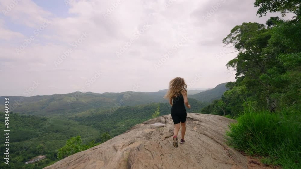 Woman in black hikes up mountain, embraces vast green panorama. Arms wide, she feels pure freedom, joy atop nature peak. Solo traveler explores, enjoys refreshing landscape, wilderness serenity. Slomo Woman in black hikes up mountain, embraces vast green panorama. Arms wide, she feels pure freedom, joy atop nature peak. Solo traveler explores, enjoys refreshing landscape, wilderness serenity. Slomo