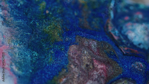 Paint spill. Glitter ink flow. Defocused blue pink black color sparkling metallic liquid pouring blend marble texture abstract art background.