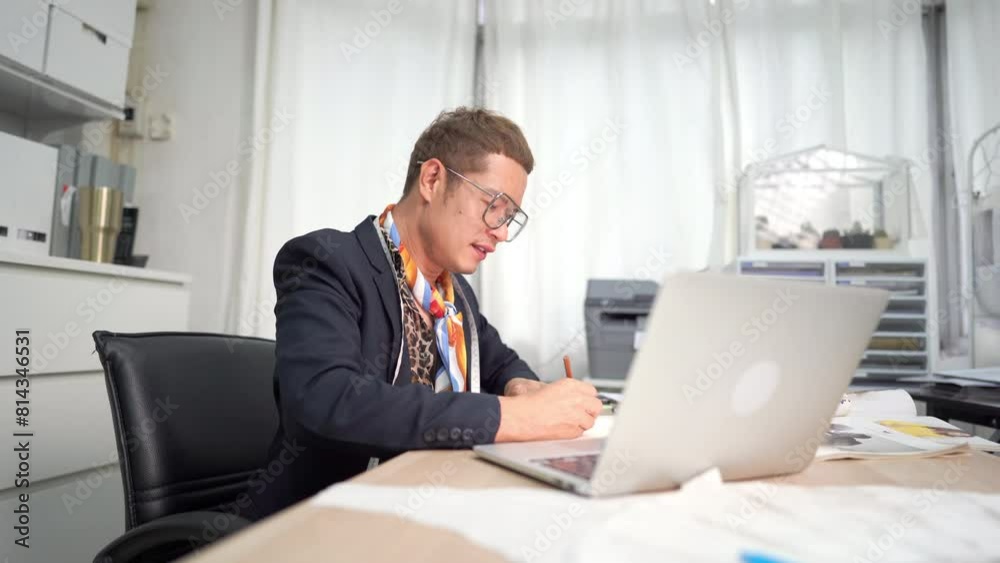 Confidence Asian LGBTQ guy bridal shop owner working and making wedding dress sewing pattern in office room at wedding studio. Small business entrepreneur wedding planner and tailor designer concept Confidence Asian LGBTQ guy bridal shop owner working and making wedding dress sewing pattern in office room at wedding studio. Small business entrepreneur wedding planner and tailor designer concept