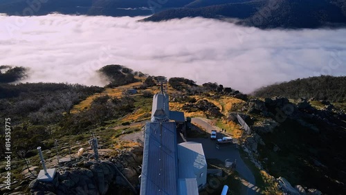 Aerial of Thredbo ski chairlift in summer with mountain cloud fog, New South Wales, Australia photo