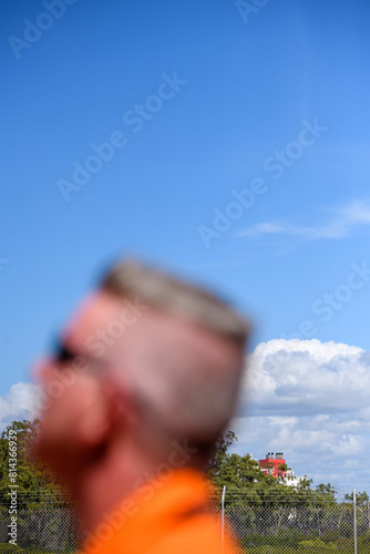worker out of focus with liquid natural gas ship in the background