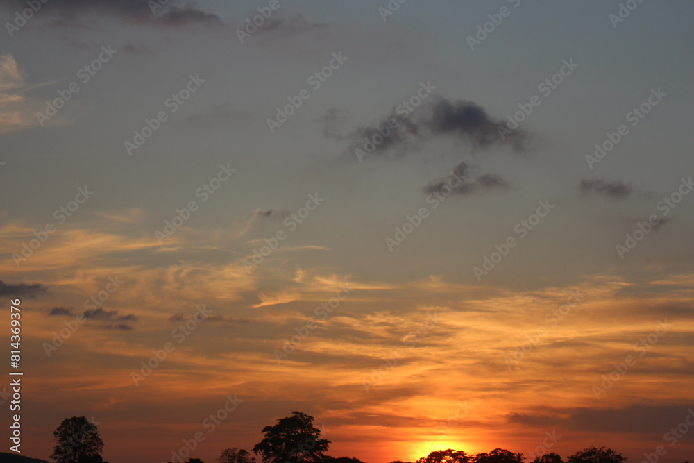 Obraz premium Natural Sunset Sunrise Over Field Or Meadow. Bright Dramatic Sky And Dark Ground. Countryside Landscape Under Scenic Colorful Sky At Sunset Dawn Sunrise. Sun Over Skyline, Horizon. Warm Colours.