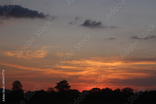 Sunset Sky Clouds in the evening with Red, Orange, Yellow and purple sunlight on Golden hour after sundown, Romantic sky in summer on Dusk Twilight © SISIRA