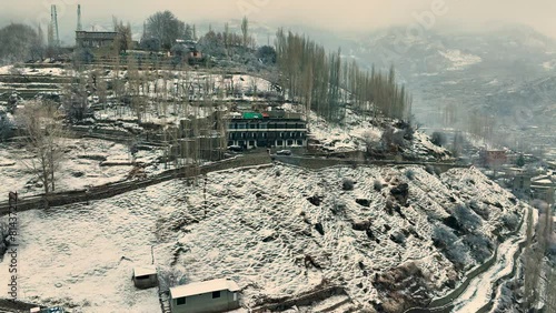 Aerial View Of Snow Covered Karimabad In Hunza Valley. Push Forward Shot photo