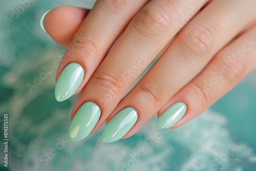 a woman's hand with a green manicure on it's nails