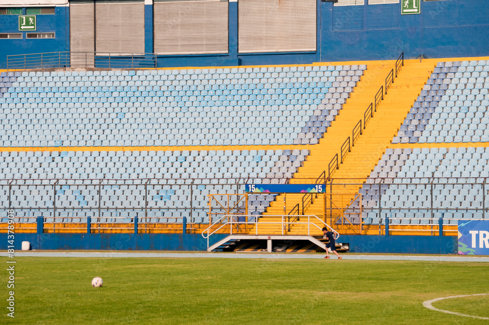 Obraz premium Empty seats in a soccer stadium in Latin America, a structure built amidst a ravine, providing space for both sporting and musical events.
