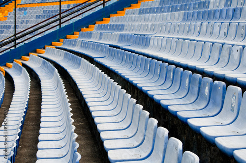 Empty seats in a soccer stadium in Latin America, a structure built amidst a ravine, providing space for both sporting and musical events.