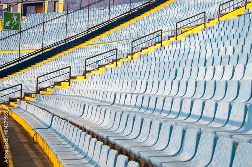 Empty seats in a soccer stadium in Latin America, a structure built amidst a ravine, providing space for both sporting and musical events.