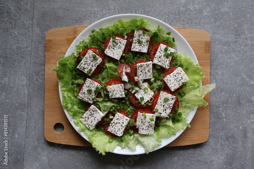 salad tomatoes cheese greens sauce seasonings