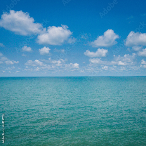 Blue sea or ocean with sky and white clouds