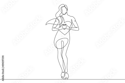 One continuous line.Beautiful woman holding a heart in her hands.Valentine's Day. Girl with a heart symbol of love. Continuous line drawing.Lineart isolated white background.