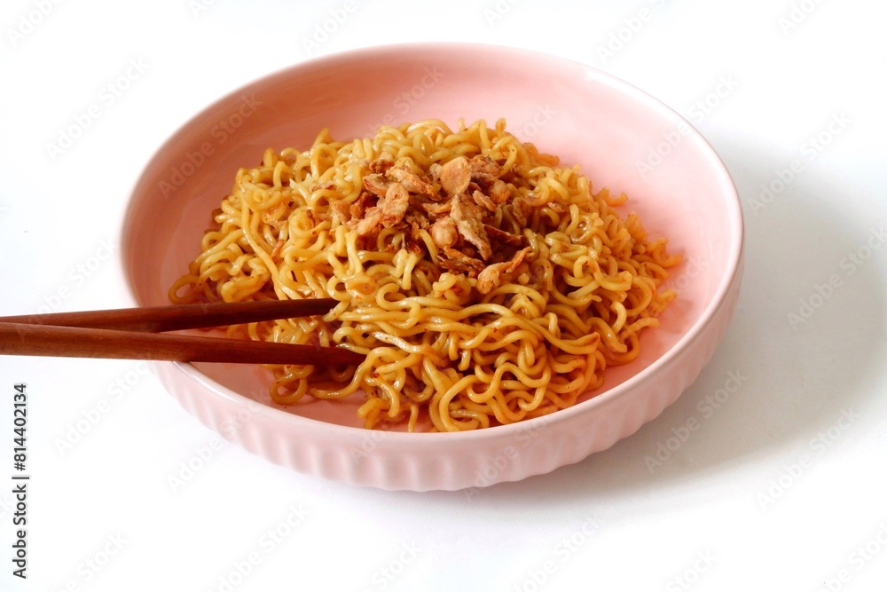 Mie goreng or Fried noodles on pink ceramic plate Mie goreng or Fried noodles on pink ceramic plate