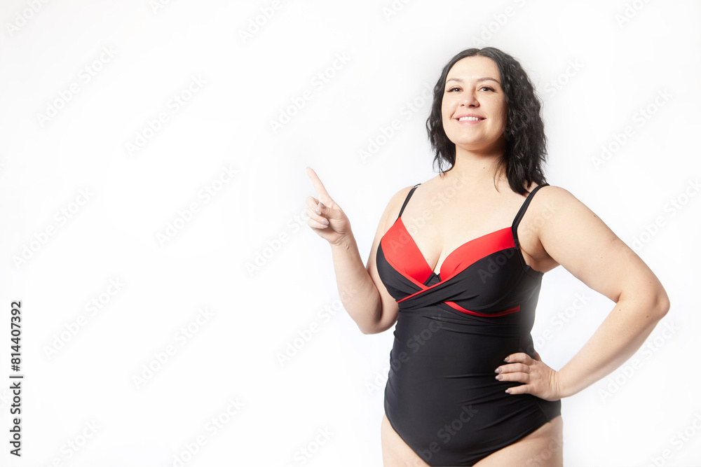 Portrait of attractive dreamy thick woman in red black swimsuit posing on white background. Body positive, photo shoot, selfie. Funny plus size model Portrait of attractive dreamy thick woman in red black swimsuit posing on white background. Body positive, photo shoot, selfie. Funny plus size model
