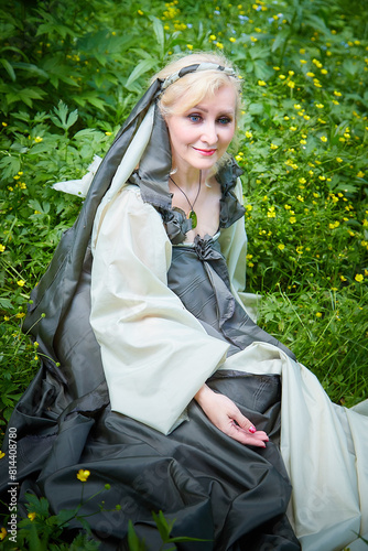 Принти на полотні Adult mature woman 40-60 in a green long fairy dress in forest