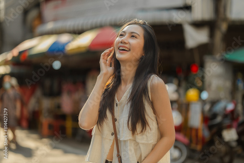 a beautiful Asian woman is walking around street food market in day time, lovely teenager is smiling and feeling happy on her holiday,  traveler gorgeous woman extremely enjoy on her vacation