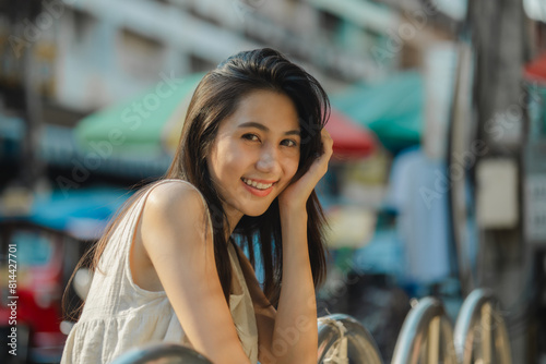 a beautiful Asian woman is walking around street food market in day time, lovely teenager is smiling and feeling happy on her holiday,  traveler gorgeous woman extremely enjoy on her vacation