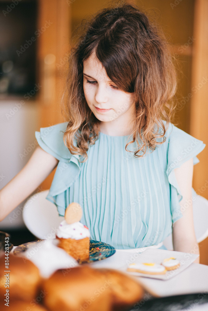 A girl decorates traditional Ukrainian pastries for Easter. A girl decorates traditional Ukrainian pastries for Easter.