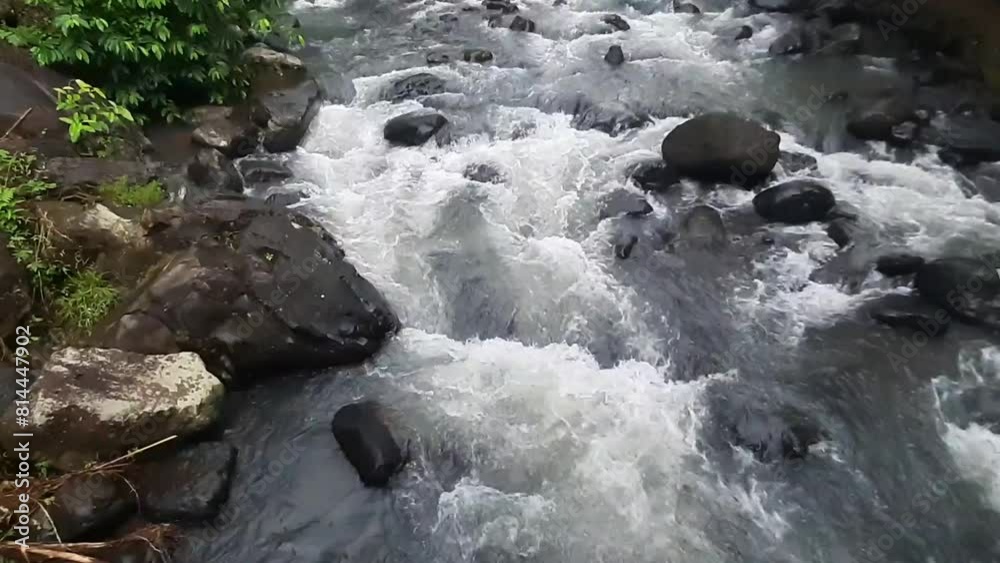 The swift flow of river water on stone at the Padarincang area, Indonesia