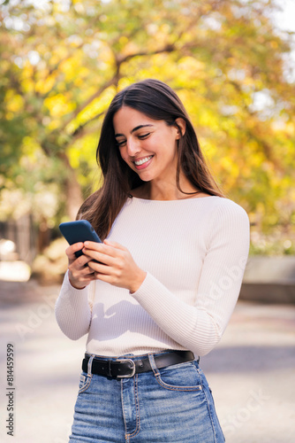 brunette woman smiling happy using her mobile phone, concept of technology of communication and modern lifestyle