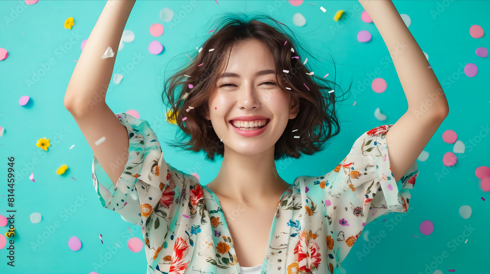 A woman is celebrating with confetti in the air. A woman is celebrating with confetti in the air.