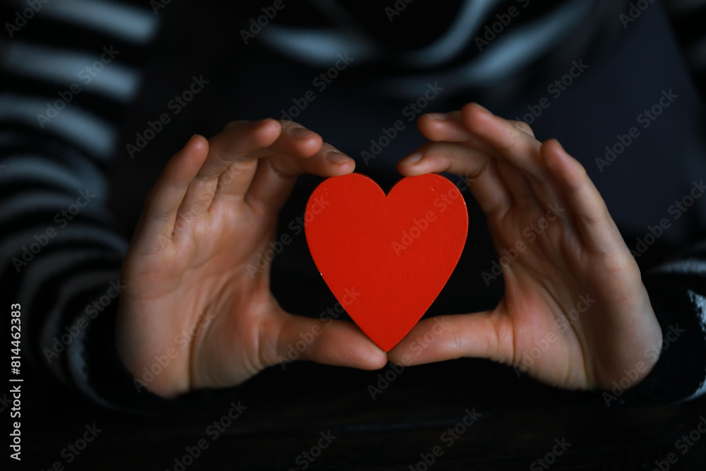 Hands of a woman holding and offering a heart shape. Love, health concept. Selective focus.Cinematic effect. Hands of a woman holding and offering a heart shape. Love, health concept. Selective focus.Cinematic effect.