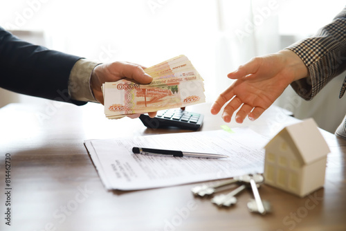 Slika na platnu Businessman giving money, Russian Ruble currency, to hs partner - payment, loan