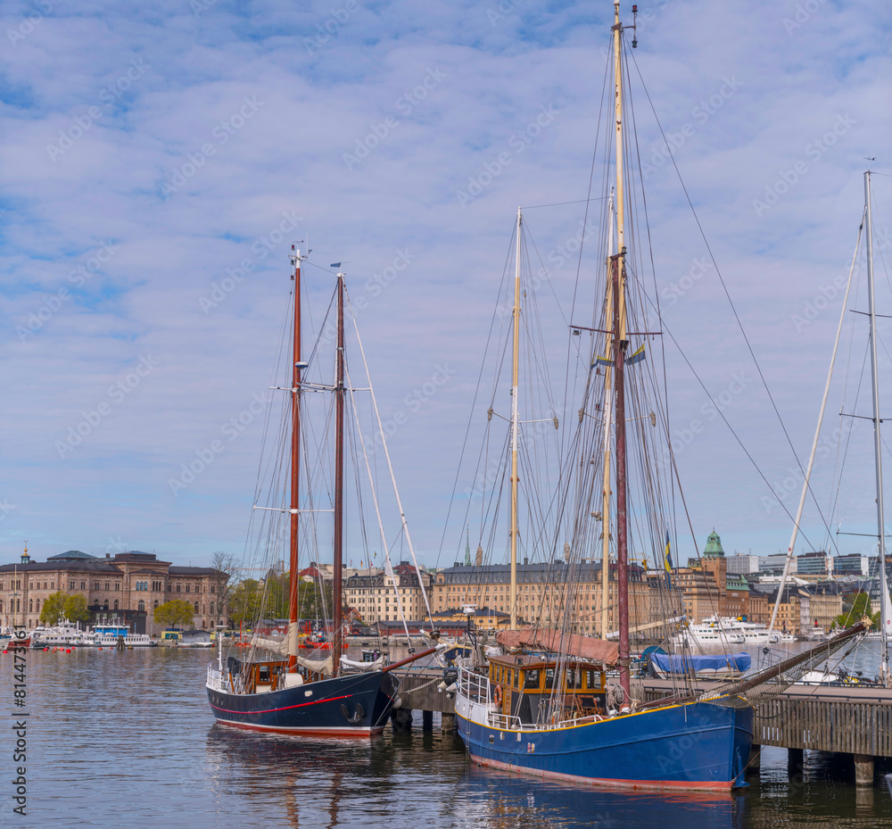 Two old sail pram ships at a pier in the bay Ladugårdslandsviken, a sunny summer morning in Stockholm Two old sail pram ships at a pier in the bay Ladugårdslandsviken, a sunny summer morning in Stockholm