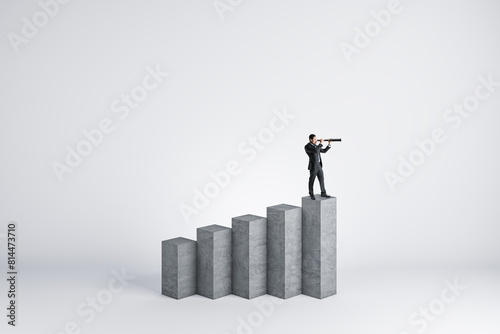 Young man with telescope standing on concrete growing business chart and looking into the distance on white background with mock up place. Financial growth  forecast and success concept.