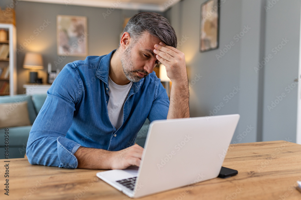 Businessman office working holding sore head pain from desk working and sitting all day using laptop computer or notebook suffering headache sick worker overworking concept Businessman office working holding sore head pain from desk working and sitting all day using laptop computer or notebook suffering headache sick worker overworking concept