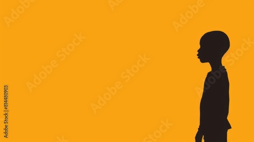 A black African boy stands alone against a vibrant orange background