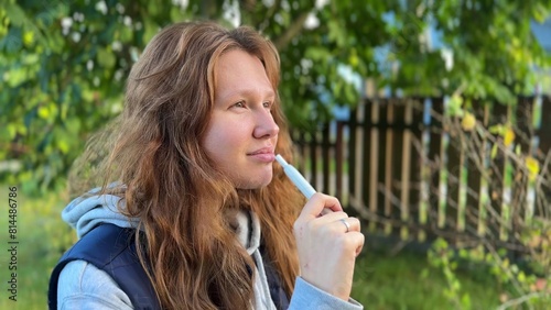 Beautiful girl, young woman is smoking, modern hybrid electronic cigarette device, technology, heating new tobacco system, puff. Healthy safety alternative to smoking. Healthcare