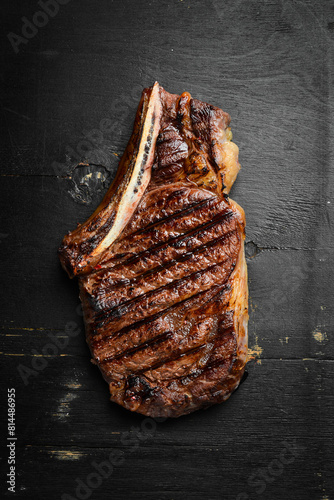 Steak. Grilled steak on the bone. Roasted piece of meat. Free space for text.