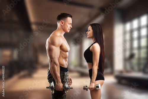 A fitness sporty young couple in a gym.