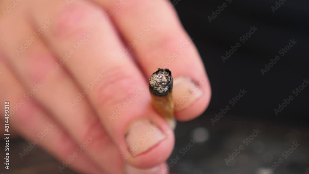 Close-up of cigarette in young man's hand Close-up of cigarette in young man's hand