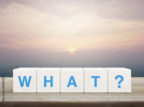 What letter on white block cubes on wooden table over modern city tower and skyscraper at sunset, vintage style, Business communication concept