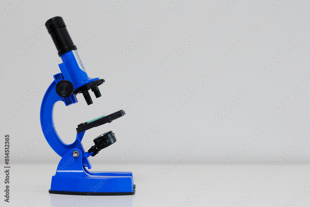 Blue metal microscope standing on table Blue metal microscope standing on table
