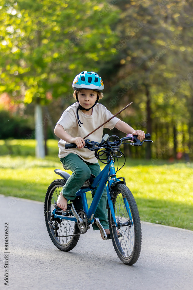 Happy beautiful child, kid, playing with small beautiful ducklings or goslings, cute fluffy yellow animal birds