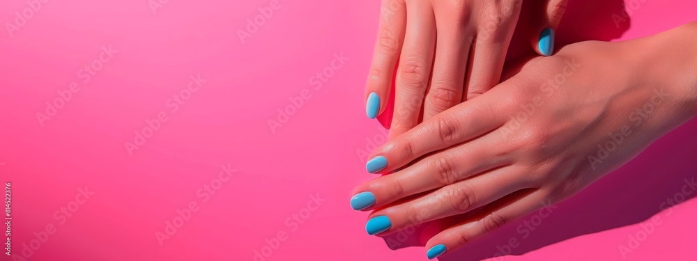 Fototapeta premium Female hands with perfect manicure in trendy neon light on pink background. Beauty concept.