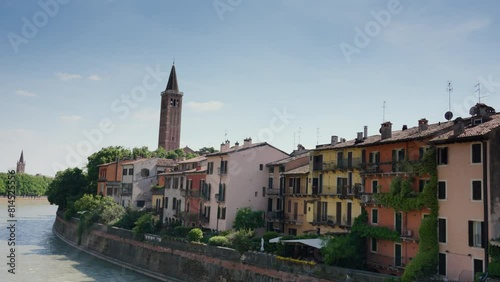 Sunny day in Verona, Italy, with historic buildings along Adige River. photo