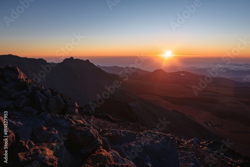 Sunrise Cresting Over Misty Mountain Ridges