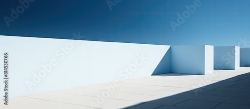 Abstract walls and architectural structures create a captivating contrast against the clear blue sky forming a modern concept with beautiful shadows Ideal for use as a copy space image