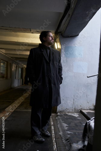 a serious man in a black coat on the street in Krasnoyarsk