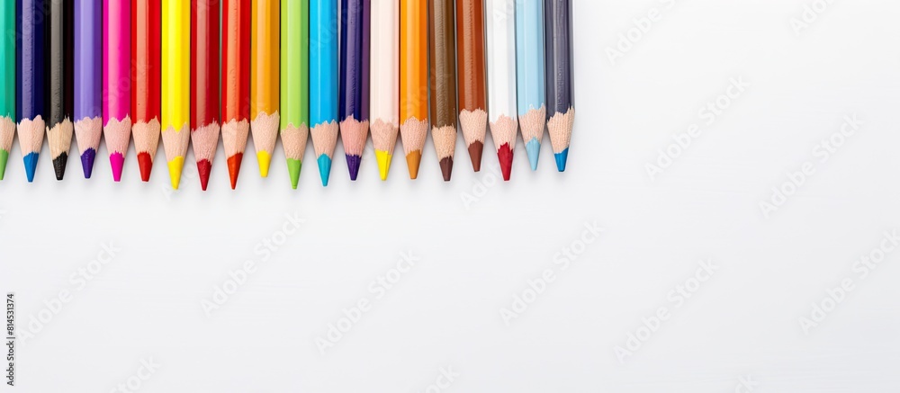 Top view of small colored pencils and sheets of white paper arranged on a table serving as a template or canvas for drawing writing or sketching with sufficient copy space image Top view of small colored pencils and sheets of white paper arranged on a table serving as a template or canvas for drawing writing or sketching with sufficient copy space image