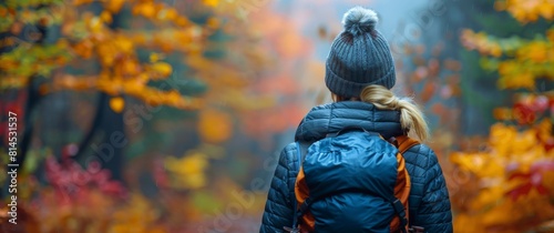 Woman in Blue Jacket Walking Through Forest